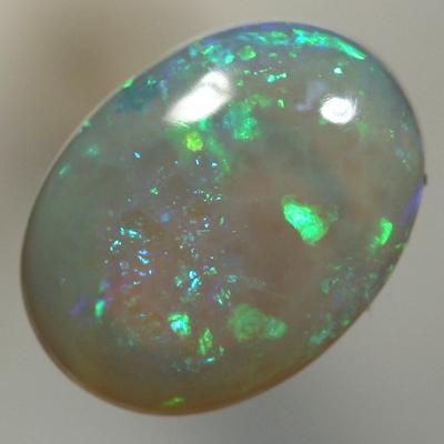 SOLID CRYSTAL OPAL Sparkles of green with orange in a 3D pattern